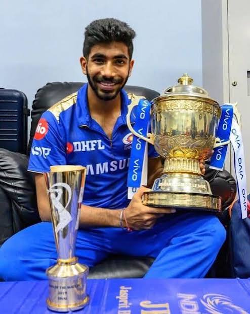 Jasprit Bumrah with the IPL trophy and his Player of the Match award
